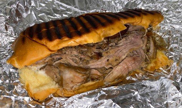 Pernil (slow roasted pork) and cheese sandwich.