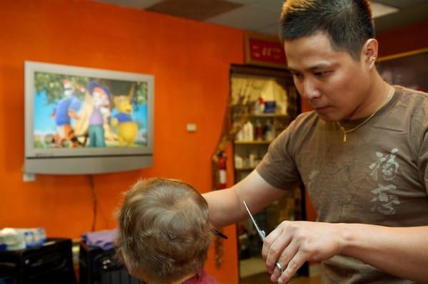 Eric distracts my 2 year old with a movie while cutting his hair.  No fuss at all and walked out with a great 1st haircut!