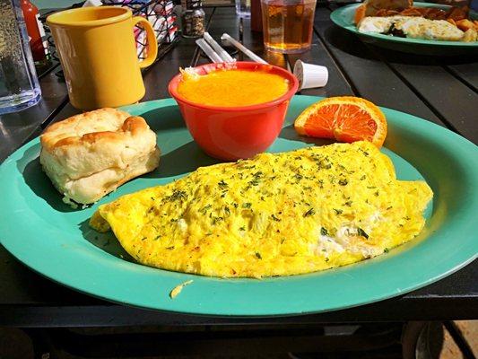 Quiche omelette with cheese grits and a biscuit.