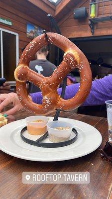 Pretzel with cheese and mustard dipping sauces