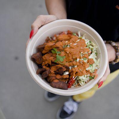 The Bowl with vegan carnitas protein, citrus slaw veggie topping, and red pepper sauce. Comes with black beans, brown rice, and pico.