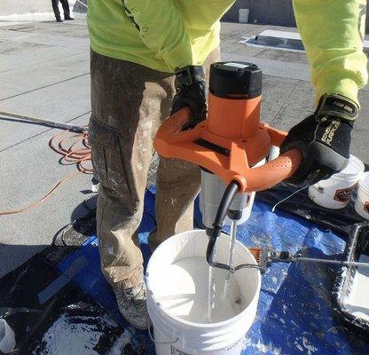 Preparing white coating for roof project.