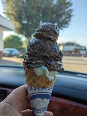 Banana cream pie and peanut butter brownie double dip on a waffle cone