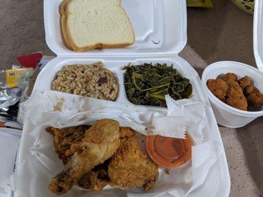 3-piece chicken dinner with sides red beans and rice & collard greens, and side of fried okra on the right.