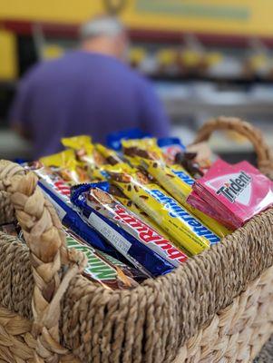 Candy basket by the register and the owner in the background