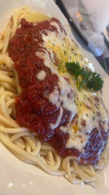 Cheese stuffed ravioli over a bed of spaghetti