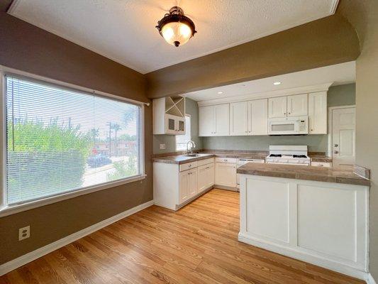 Large bright open plan kitchen with dining counter and accent colors