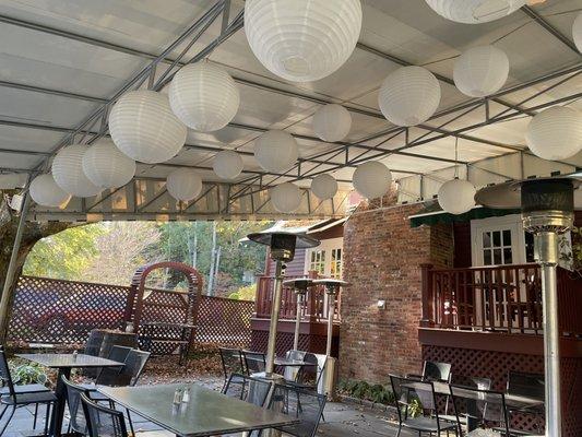 Outdoor seating area with white pater lanterns.