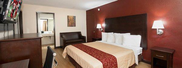 Hotel room, King bed. All of our rooms offer wonderful wood-like flooring.