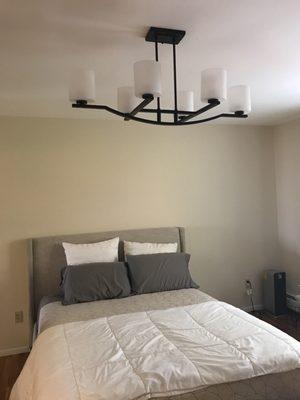 The large chandelier that Sergio skillfully hung in the bedroom.