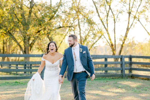 Bride and groom first look excitement. Fall leaves and farm fence in background.