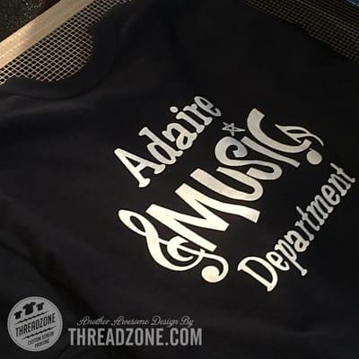 Behind the scenes at Threadzone.  Adaire music shirts coming off the dryer.