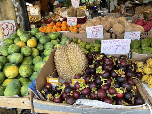 Husked coconuts, fresh papayas, durian and mangosteen