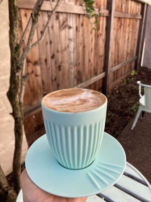 Latte with pistachio milk in their cute mug