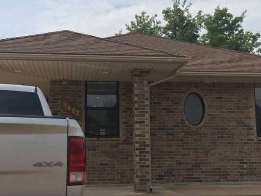 Front of building - blends in with the houses except it has a parking lot.