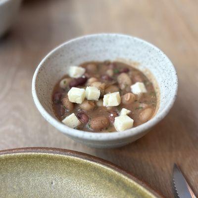 HEIRLOOM BEANS SHEEP'S MILK AGED FETA, GARLIC CHIVE CAPERS