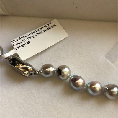 I received this blue Akoya pearl necklace today . Notice that black chip near the clasp? Very disappointing .