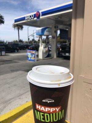 Medium covfefe in front of gas pumps. Nothing happy about brew.