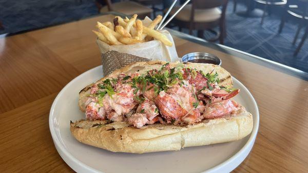 Maine Lobster Roll Sandwich featuring lobster claw meat, celery, lemon and aioli on a Brioche roll.  Served with French fried.