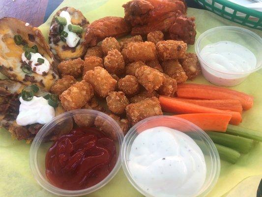 Sampler Platter: wings, onion rings, potato skins, veggie sticks and dipping sauces. We swapped the rings for tator tots.