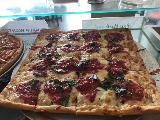 Famous Grandma Pie - made with fresh basil, rustic fresh tomato sauce, and mozzarella cheese.