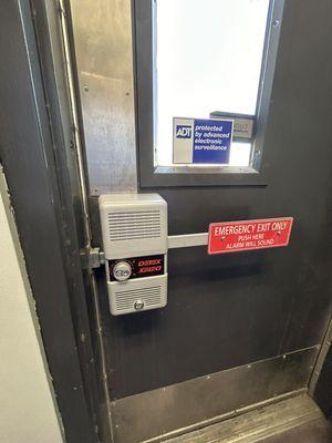 Commercial locksmith installing a DETEX alarm Lock in Chatsworth