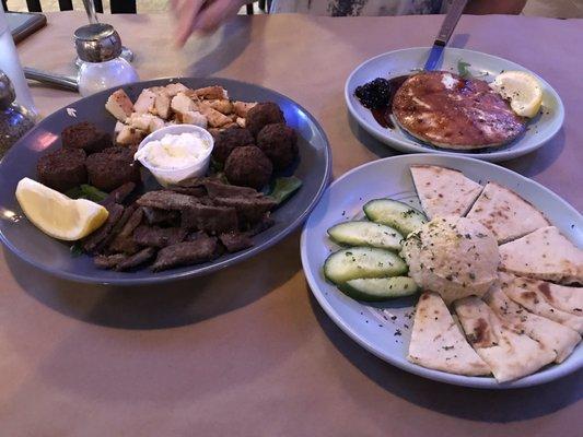 Saganaki Cheese in the background, Keftedes, chicken, falafel, chicken on left, humus on right.