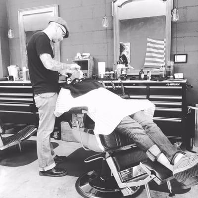 Jim (owner/barber) giving a hot straight-razor shave.