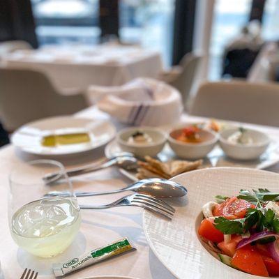 Appetizers of Greek salad and a hummus plate.