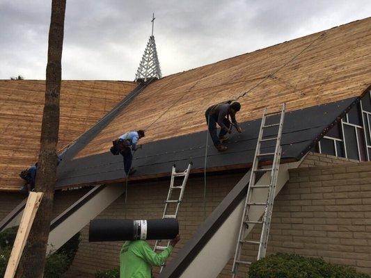 Putting a new roof on a church.