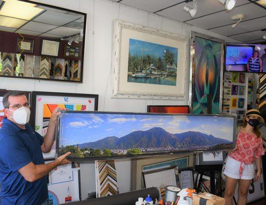 Customer Picking up framed Canvas from their trip