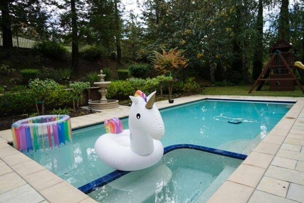 Pool resurfacing with white pebble and blue tile