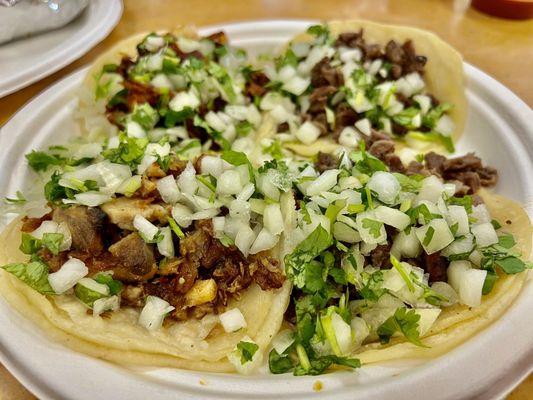 Carne asada, carnitas and el pastor tacos plate