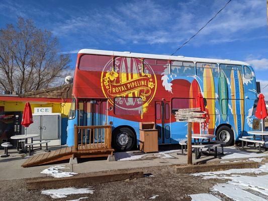 Double decker bus has tables for dining.  Order at the front widow of the diner and they "deliver" your order to the bus!