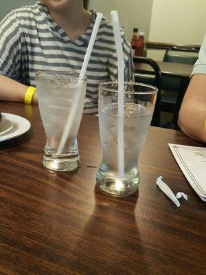 With glasses filled with ice and straws