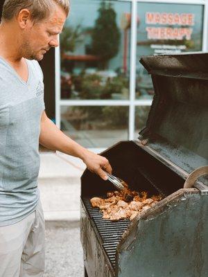 Dr. Jason Henke grilling chicken at our Annual BBQ!