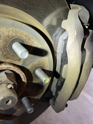 Front brakes with missing hardware and marks from being banged into the caliper.