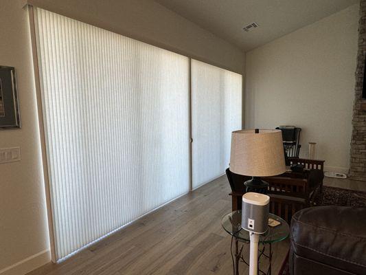 Hunter Douglas honeycomb shades on a vertiglide system. When opened, it only stacks 6 1/2 inches on each side.