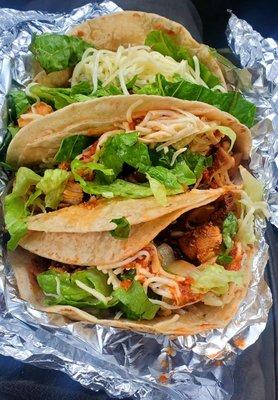 Chicken soft tacos, with brown rice, black beans, lettuce, cheese, and a little hot sauce.