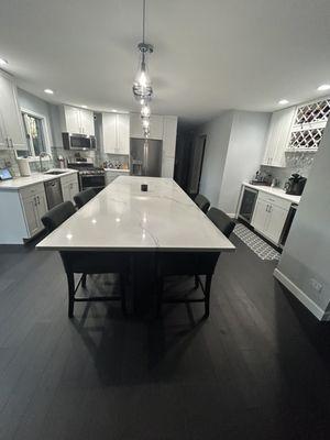 A completed kitchen done by Granite Mountain with an 11 foot quartz island