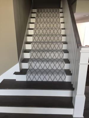 Custom solid wood tred staircase Tuftex carpet runner down the middle.