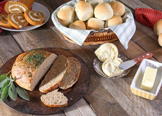 Sage & Thyme Stuffing Bread, Honey White Rolls, Pumpkin Cream Cheese Log. Thanksgiving spread.