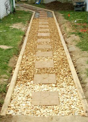 Area was always soaked. We installed a Timber wrapped walkway with river rock and stepping stones for a safe and economical solution.