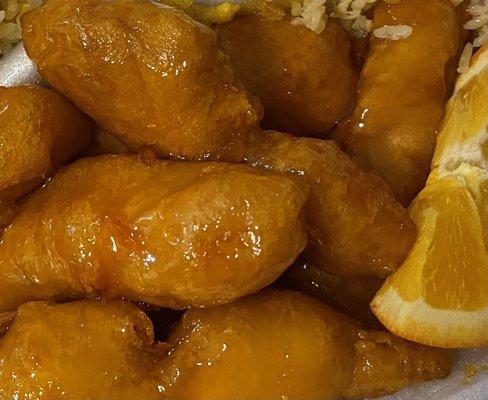 Orange Chicken covered in a light soft breading coated in the perfect sauce ... loaded with orange flavor !