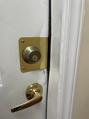 Brass plate to cover door damage