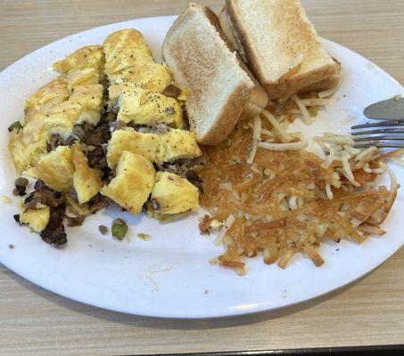 Philly Cheesesteak omelette with hash browns and toast.