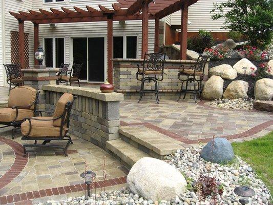 A bar area under the pergola in the outdoor living space.