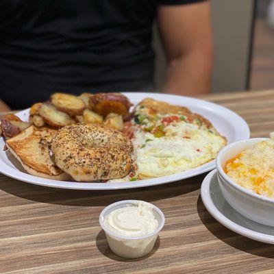 Veggie egg white omelet , house potatoes , grits with cheese, everything bagel toasted with cream cheese.