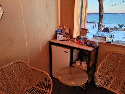 The room has a mini fridge, coffee maker&cups, Bluetooth speaker and cute table and chair set