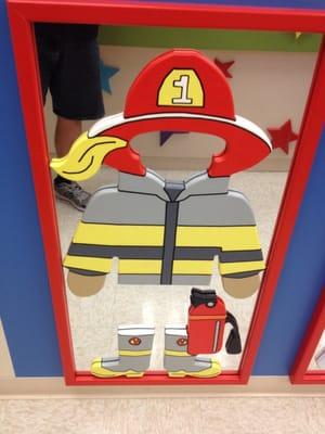 Mirror with firefighter. You stand in front and you are dressed as a firefighter